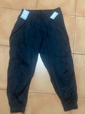 Black XL pants with draw string tie and elastic bottoms. Brand new with tags
